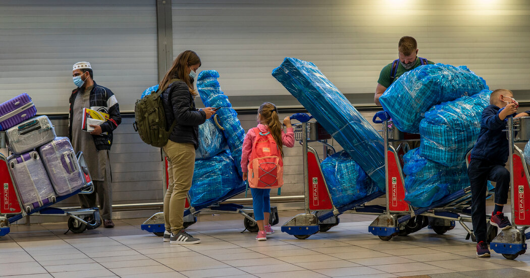 Omicron Variant Prompts Travel Bans and Batters World Markets – The New York Times